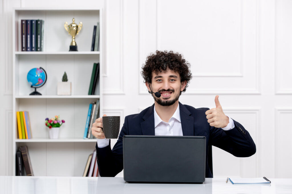 customer service handsome curly man office suit with computer headset happy coffee