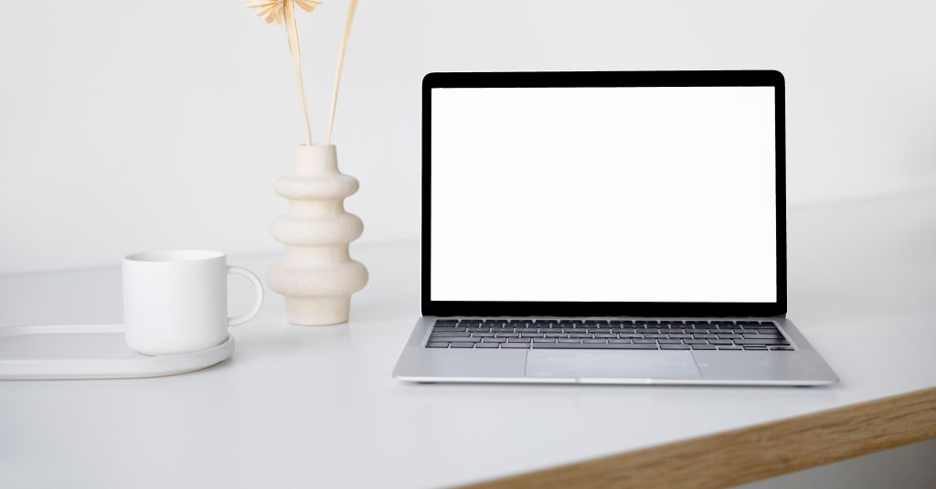 Laptop mockup on a styled desk, screen shows Digitalwikier growth dashboard